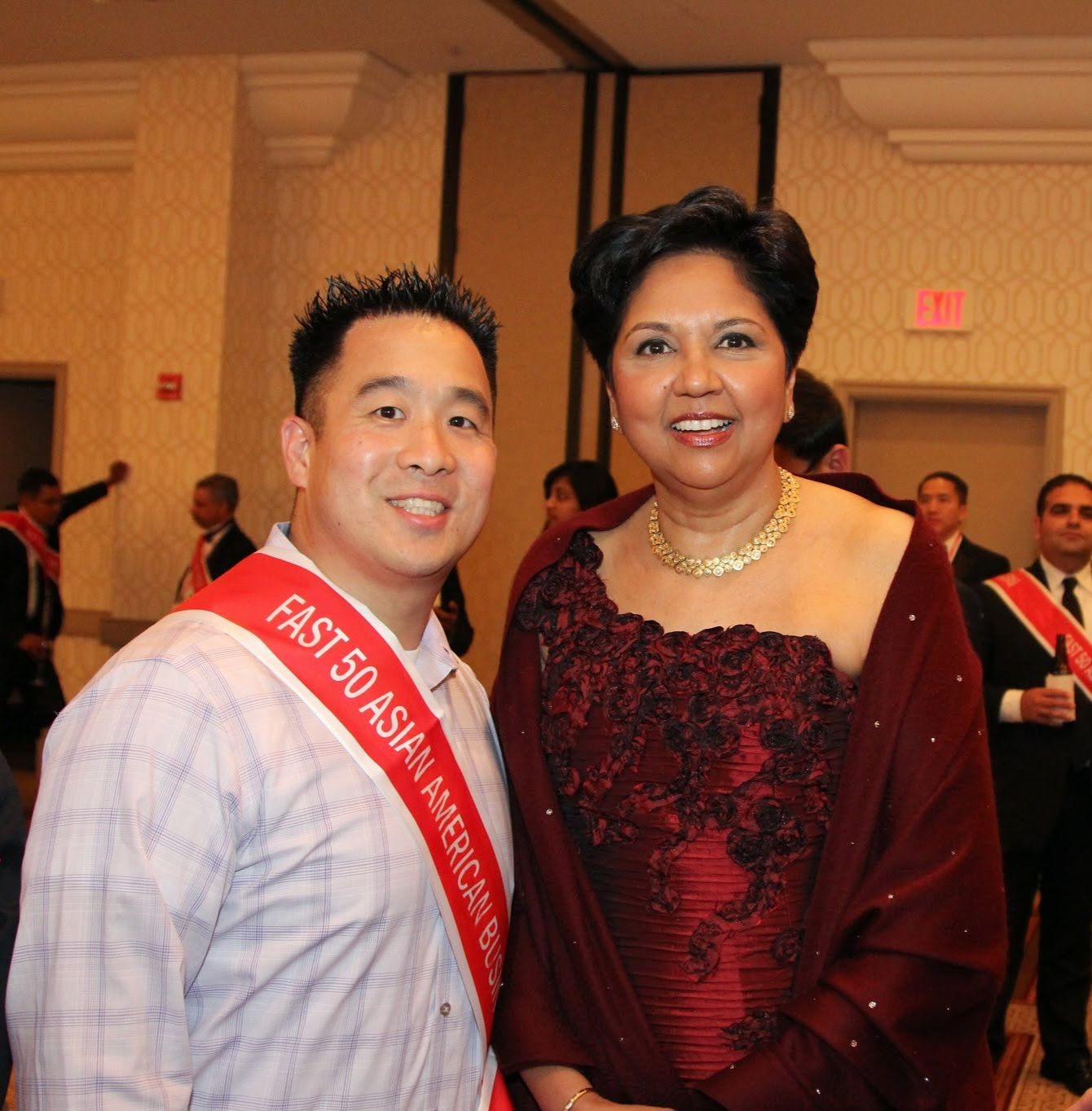 Tejune Kang wearing the Fast 50 Asian American sash with Indra Nooyi
